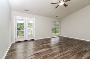 Marietta house for rent - A room with a ceiling fan and a door leading outside.