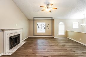 Hiram house for rent - A spacious room with a fireplace and a large window.