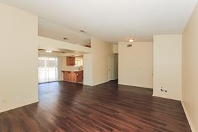 Hemet house for rent - A large empty room with wooden floors and white walls.