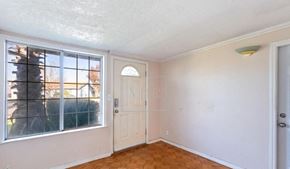 Elverta house for rent - an empty living room with a white door and a window