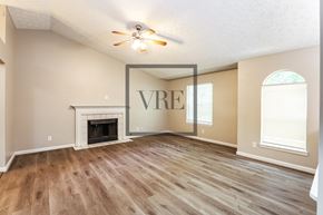 Hiram house for rent - A living room with a fireplace and a ceiling fan.