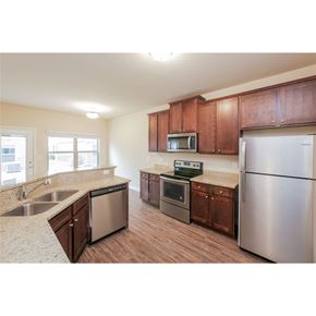 Mcdonough house for rent - A kitchen with brown cabinets and stainless steel appliances.