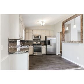 Stone Mountain house for rent - a kitchen with white cabinets and stainless steel appliances