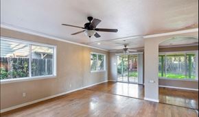 Elverta house for rent - an empty living room with a ceiling fan and a sliding glass door