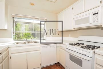 Lancaster house for rent - A kitchen with a white stove and cabinets with a VRE sign.