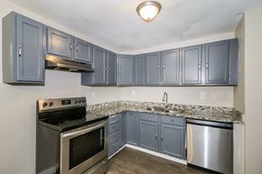 Newnan house for rent - A kitchen with a stove, oven, and cabinets.