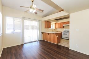 Hemet house for rent - A kitchen with wooden floors and a ceiling fan.