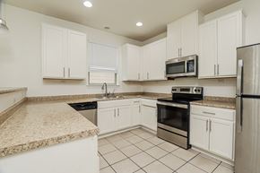 San Antonio house for rent - A kitchen with white cabinets and appliances.