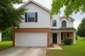 Lithonia house for rent - A white house with a black door and a garage.