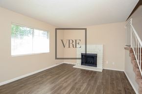 Lancaster house for rent - A living room with a fireplace and a large VRE picture on the wall.