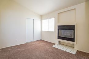 Palmdale house for rent - A living room with a fireplace and a sliding door.