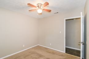Newnan house for rent - A room with a ceiling fan and a door.