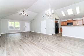 Cartersville house for rent - A spacious room with wooden flooring and a ceiling fan.