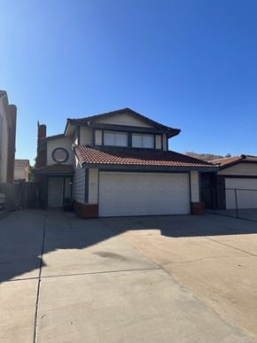 Moreno Valley house for rent - a house with a driveway and a garage door