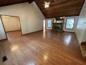 Marietta house for rent - A room with wooden floors and a fireplace.
