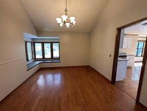 Marietta house for rent - A room with wooden floors and a chandelier.