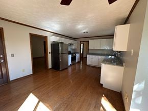 Marietta house for rent - A kitchen with a refrigerator, sink, and cabinets.