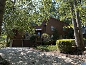 Marietta house for rent - A house with a brown roof and a driveway in front of it.