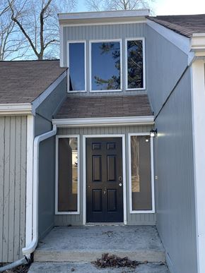 Douglasville house for rent - A house with a grey exterior and a dark brown door.