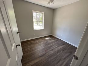 Jonesboro house for rent - A room with a wooden floor and a window.