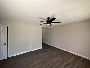 Jonesboro house for rent - A room with a ceiling fan and wood flooring.