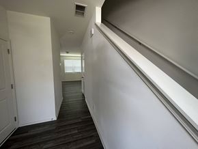 Mcdonough house for rent - a look down the hallway of a house with white walls and stairs