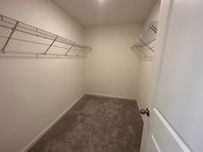 Mcdonough house for rent - an empty bedroom with a closet and a wire shelf on the wall