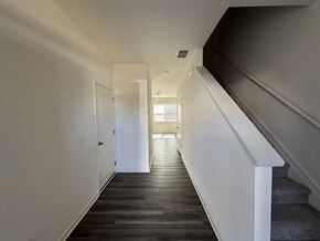 Mcdonough house for rent - a view of the hallway from the bottom of the stairs looking into the living room