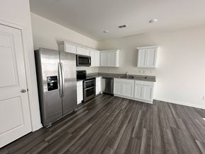 Mcdonough house for rent - a kitchen with stainless steel appliances and white cabinets