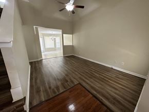 Cartersville house for rent - an empty living room with wooden floors and a ceiling fan
