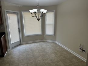 Cartersville house for rent - an empty dining room with two windows and a chandelier