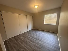 La Quinta house for rent - an empty bedroom with wood floors and a window