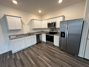 Mcdonough house for rent - a kitchen with white cabinets and stainless steel appliances