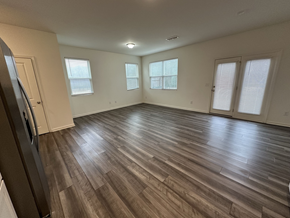 Mcdonough house for rent - an empty living room with wooden floors and windows