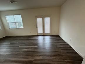 Mcdonough house for rent - an empty living room with wooden floors and white walls