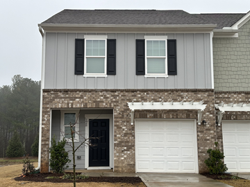 Mcdonough house for rent - a house with two garage doors and two white doors
