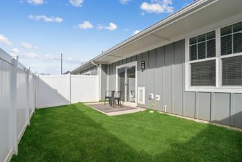 Small backyard with a white fence