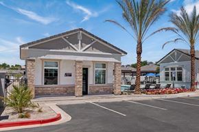 Phoenix apartment for rent - the front of a building with palm trees and a parking lot at Zora Encanto, Arizona