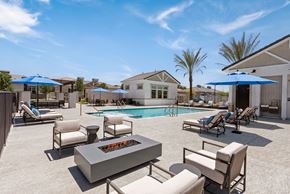 Phoenix apartment for rent - a swimming pool with chairs and tables and umbrellas at Zora Encanto, Arizona 85035
