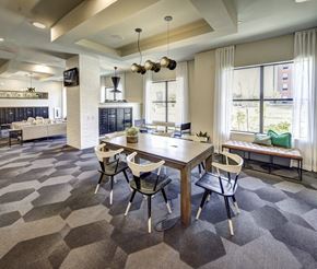 Austin apartment for rent - A modern dining room with a wooden table and chairs at Arise Riverside Apartments, Texas