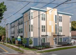 Lakeland apartment for rent - A modern apartment building with a blue and beige facade.