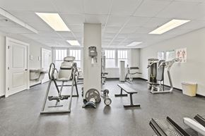 Lakeland apartment for rent - a gym with various machines and weights in it
