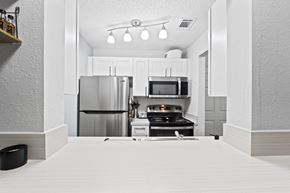 Lakeland apartment for rent - a kitchen with stainless steel appliances and white cabinets