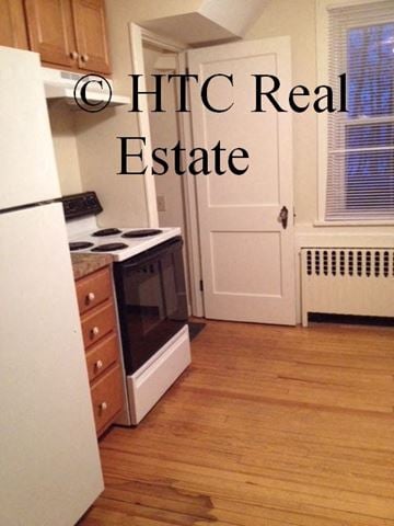 Hershey apartment for rent - A kitchen with a white refrigerator and a white door.