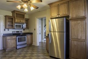 Hershey apartment for rent - a kitchen with stainless steel appliances and wooden cabinets