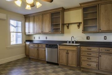 Hershey apartment for rent - A kitchen with wooden cabinets and a checkered floor.