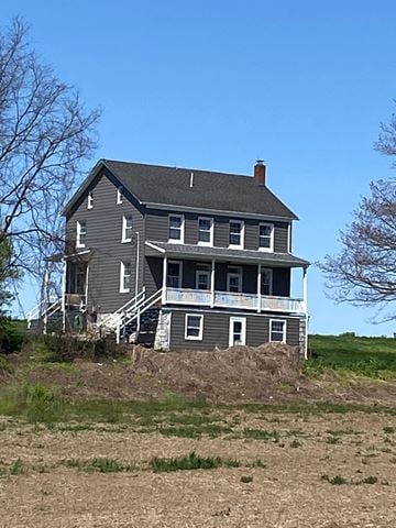 Hummelstown apartment for rent - A large house with a porch sits on a hill.