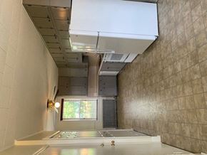 Hummelstown apartment for rent - A room with a large window and a white ceiling with a vent.