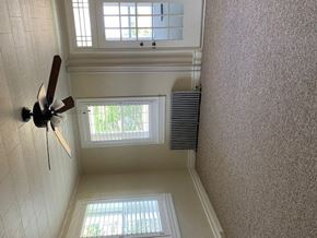 Hummelstown apartment for rent - A ceiling fan is mounted on a wall in a room with a window.