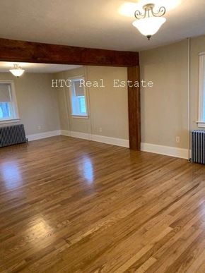 Elizabethtown apartment for rent - A room with wooden floors and a chandelier.